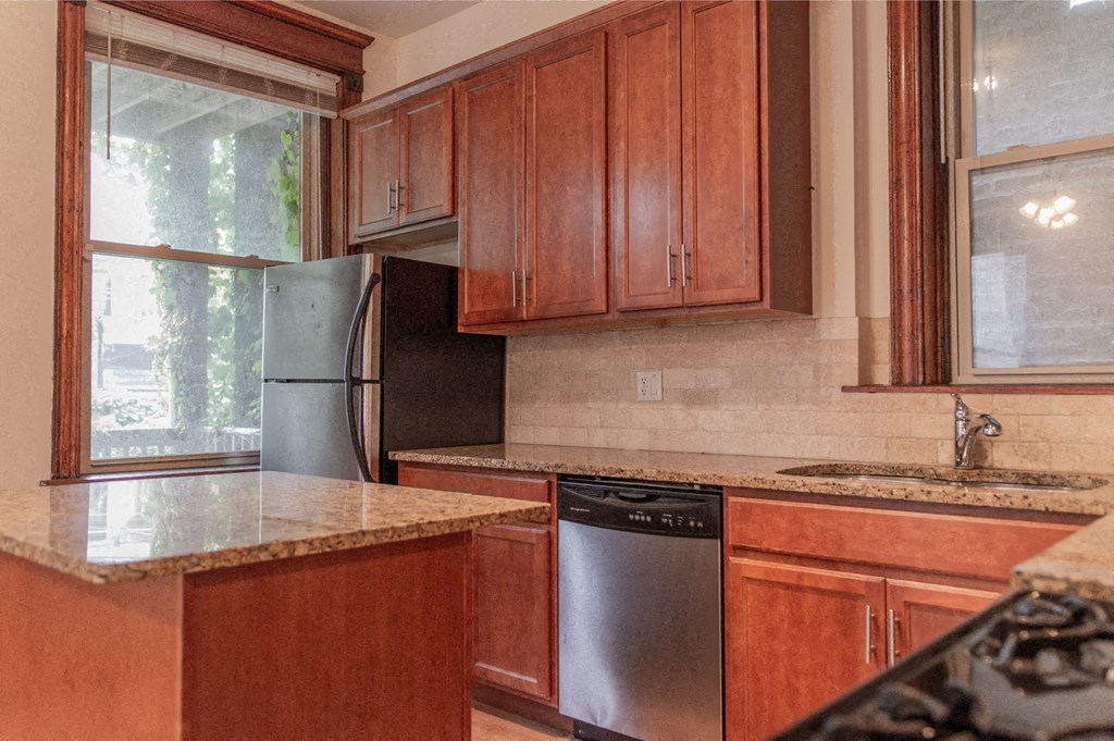 a kitchen with wooden cabinets and stainless steel appliances