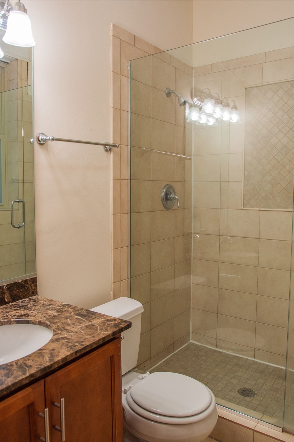 a bathroom with a shower and a sink and a toilet