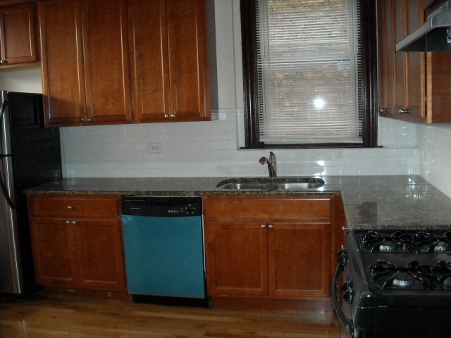 an empty kitchen with a sink and a dishwasher