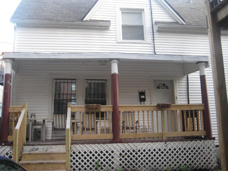a white house with a porch and a white fence