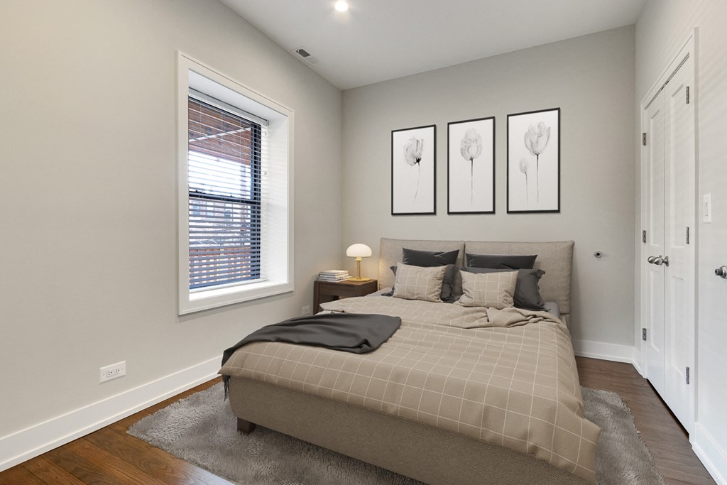 a bedroom with a bed and three pictures on the wall