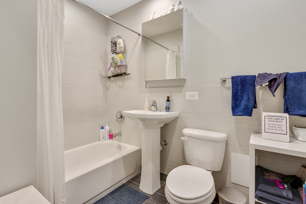a bathroom with a sink toilet and a bath tub