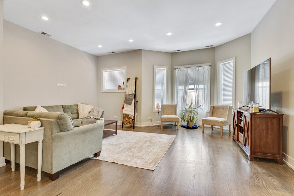 a living room with a couch and two chairs