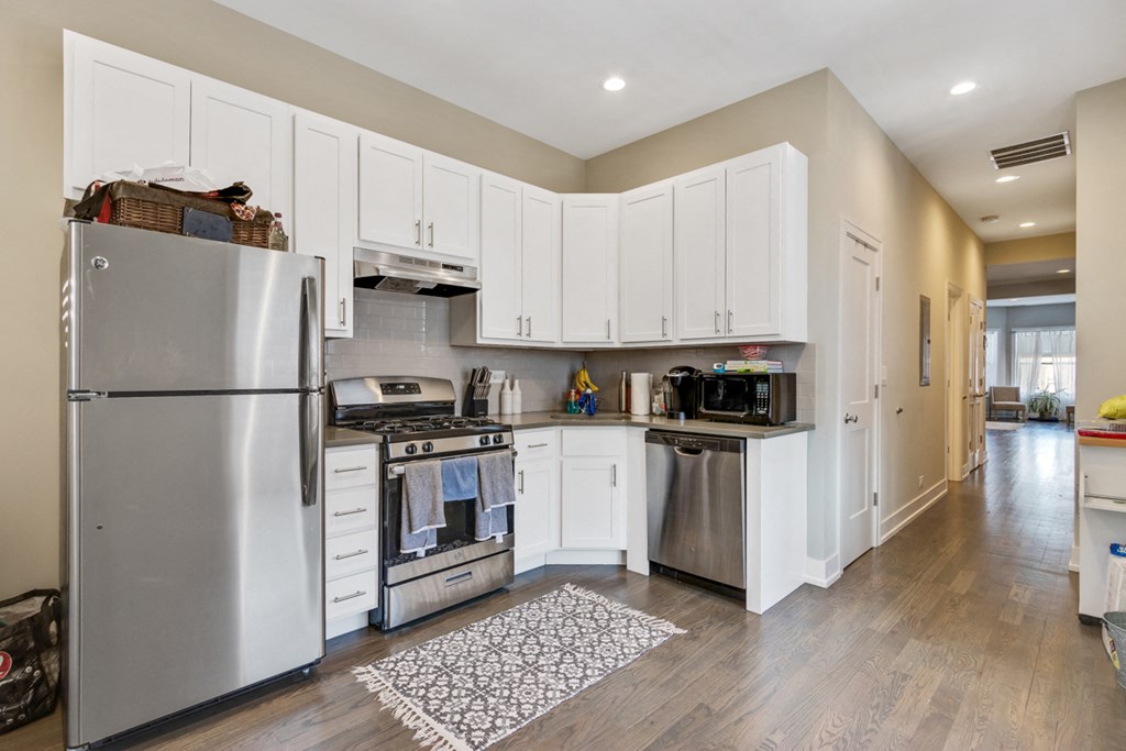 a kitchen with stainless steel appliances and white cabinets