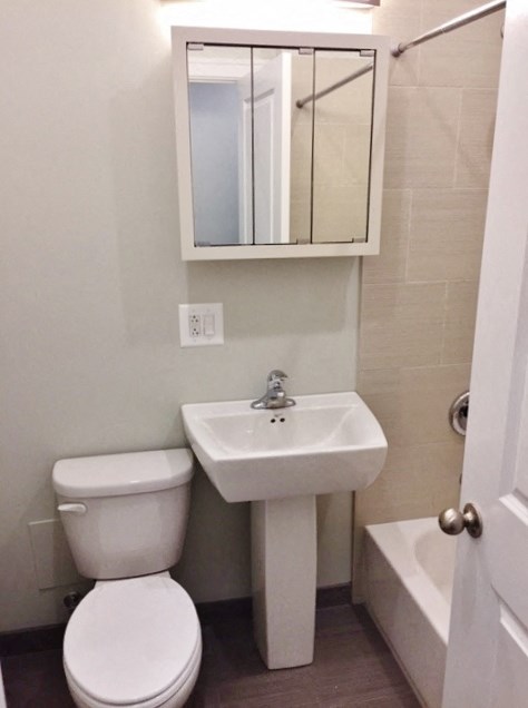 a small bathroom with a sink toilet and a mirror