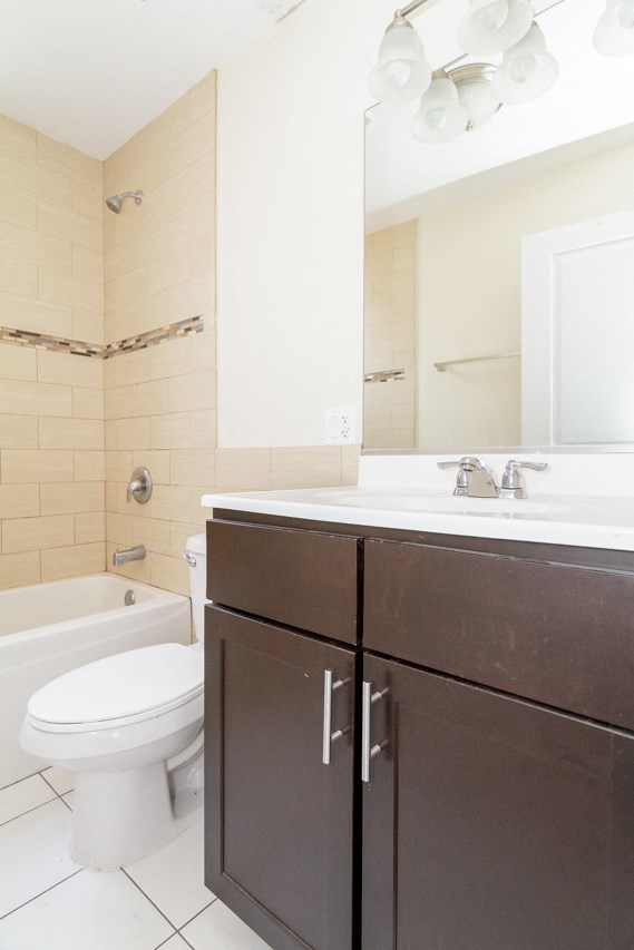 a bathroom with a toilet and a sink and a mirror