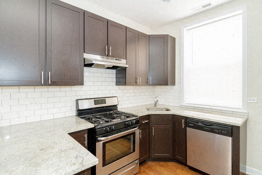 a kitchen with stainless steel appliances and wooden cabinets