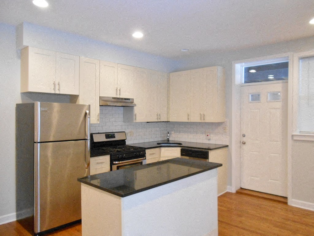 a kitchen with stainless steel appliances and white cabinets