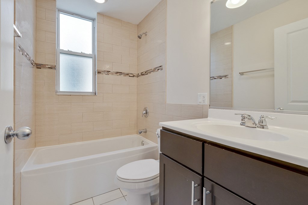 an empty bathroom with a sink toilet and bath tub
