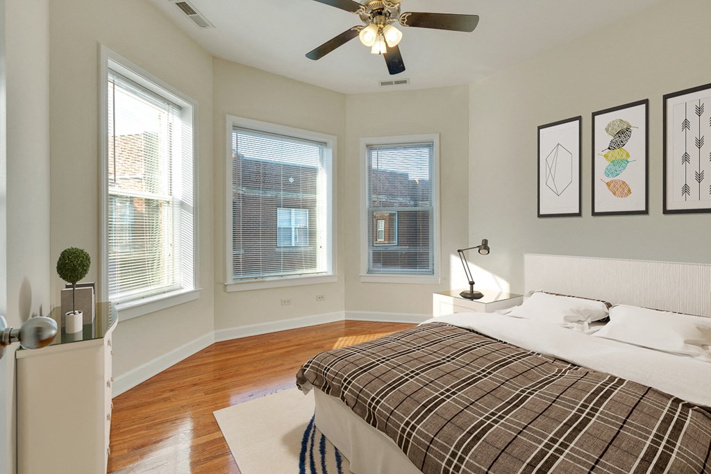 a bedroom with a bed and a ceiling fan