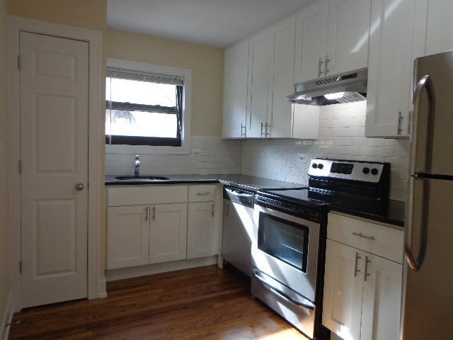 a kitchen with a stove and a refrigerator
