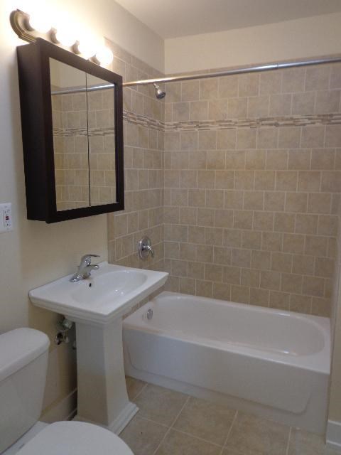 a bathroom with a sink toilet and a bath tub