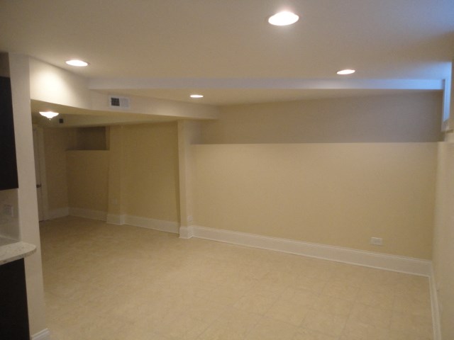 an empty room with white walls and a tiled floor