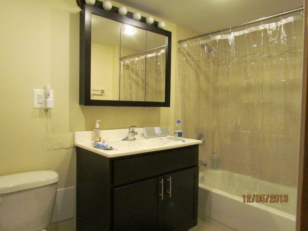 a bathroom with a sink toilet and a mirror