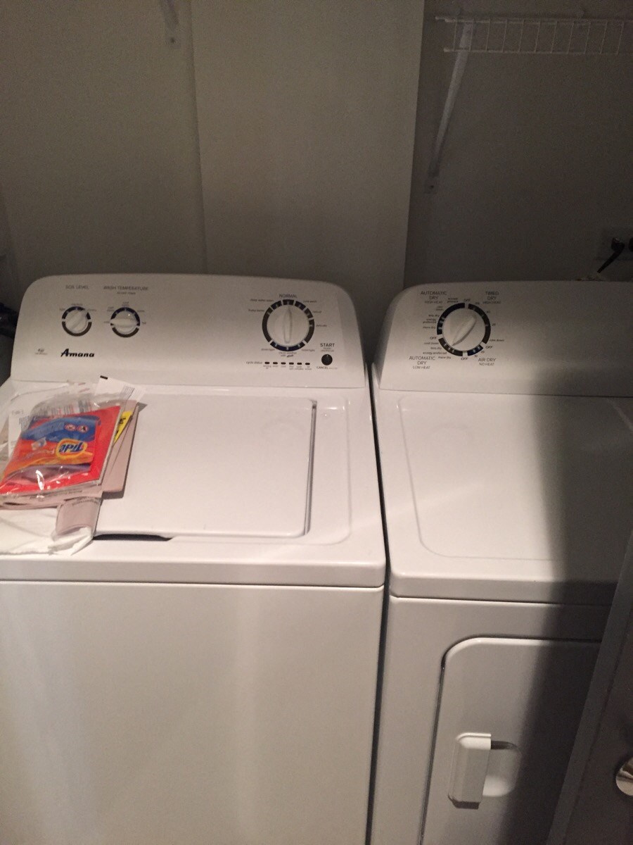 two washer and dryer machines in a laundry room