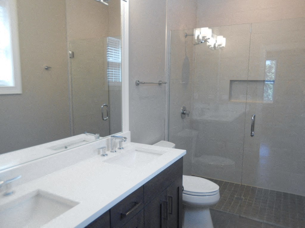 a bathroom with a toilet sink and a shower