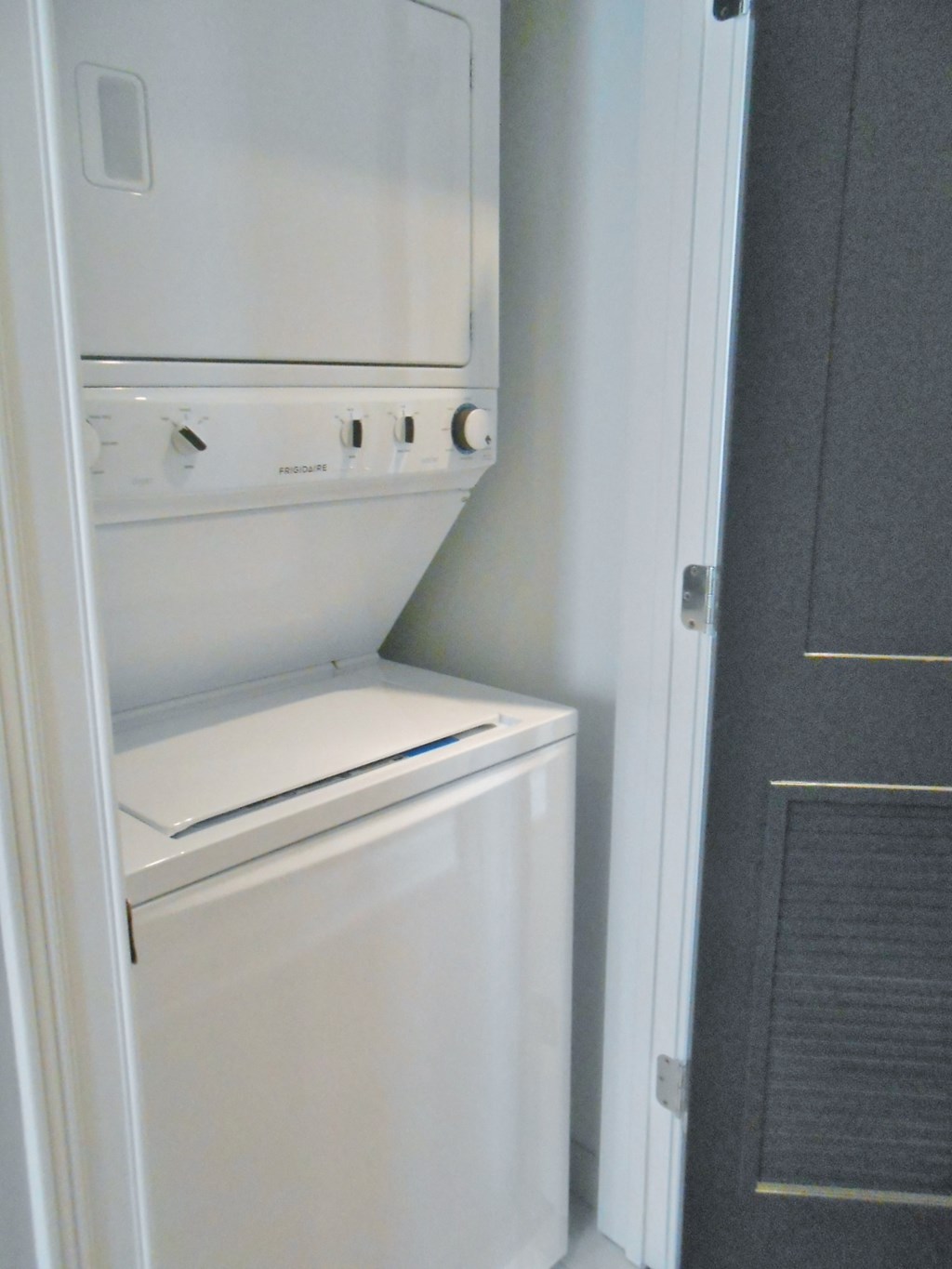 the laundry room has a washer and dryer and a door to the closet