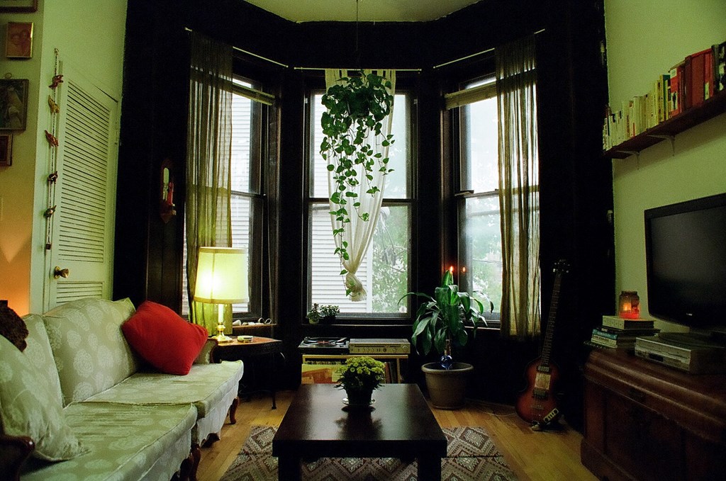 a living room with a white couch and a large window