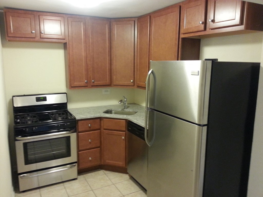 a kitchen with stainless steel appliances and wooden cabinets