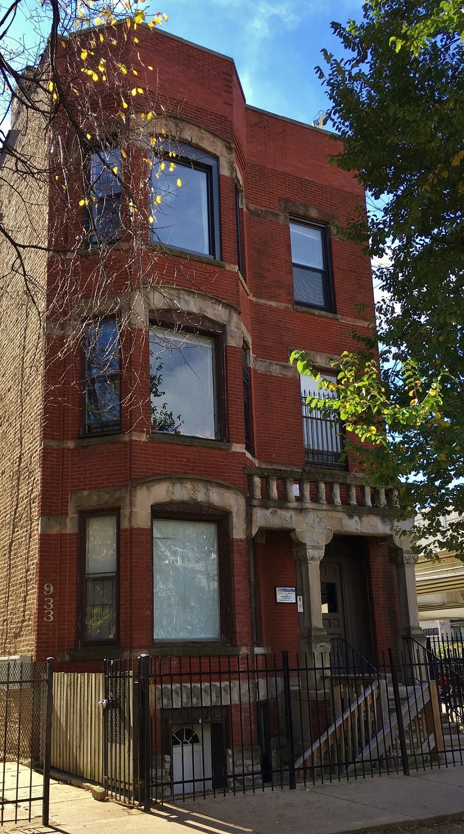 a red brick building with a fence in front of it