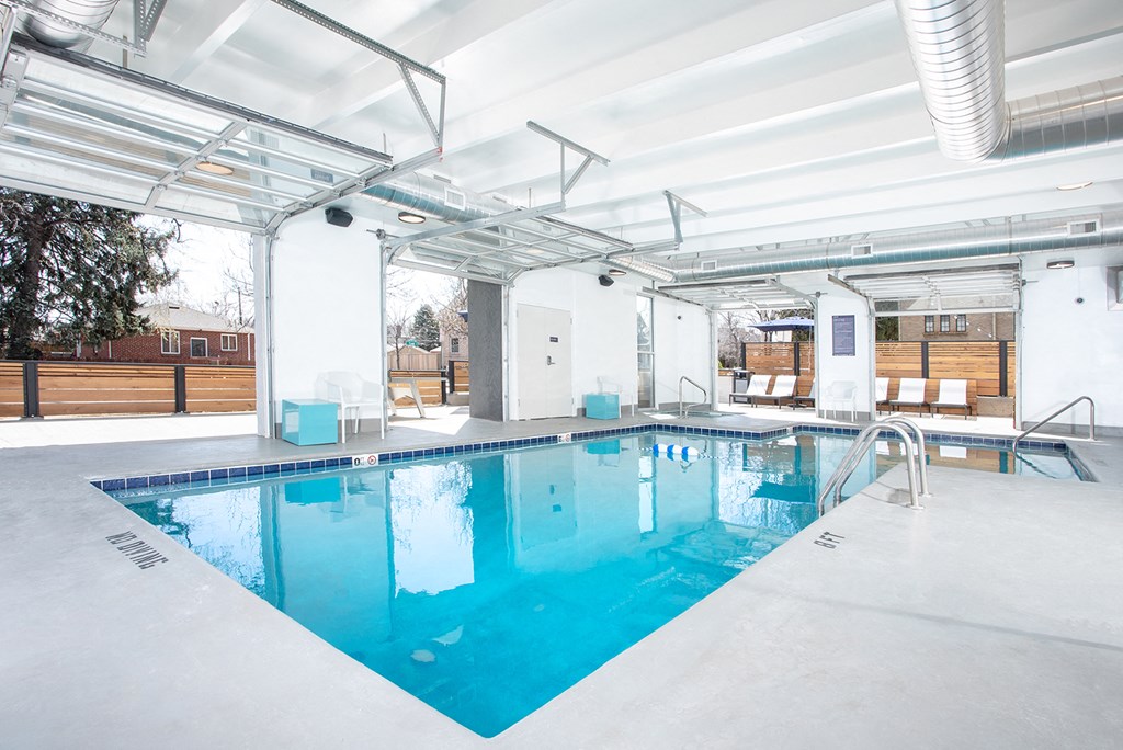a swimming pool in a building with a glass ceiling