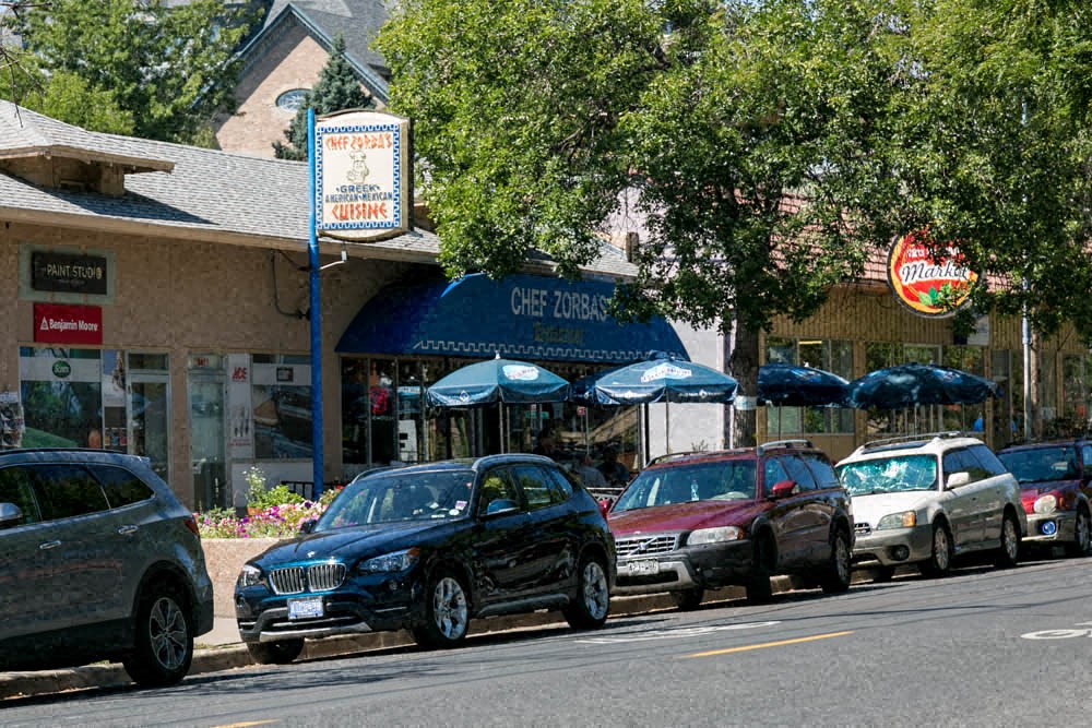 a row of cars parked on the side of a street