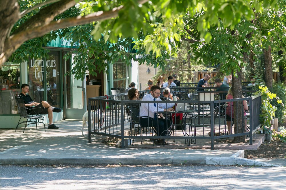 people sitting at tables in a park