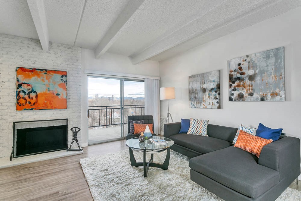 a living room with a couch and a table and a fireplace