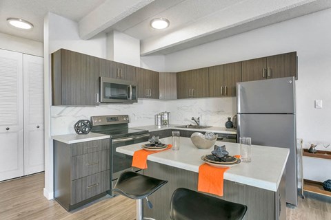 a kitchen with stainless steel appliances and a counter top