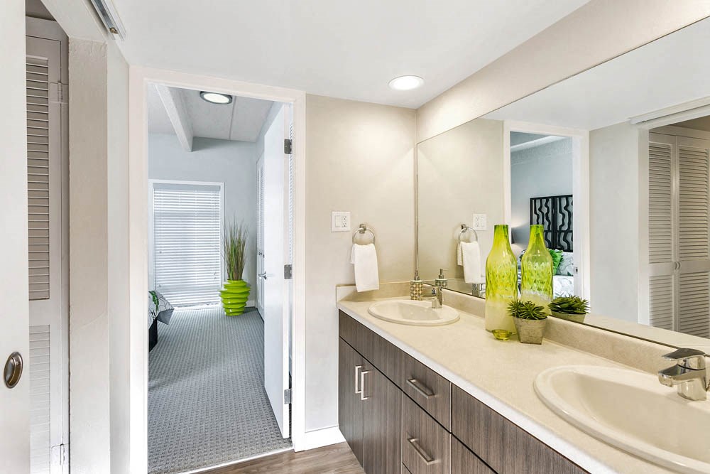 a bathroom with two sinks and a large mirror