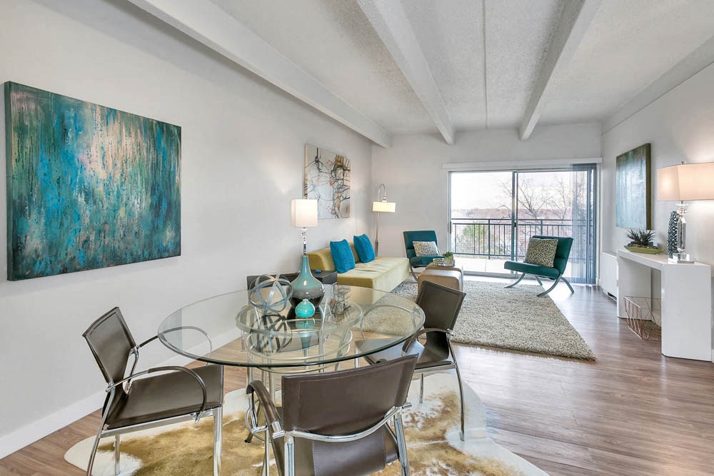 a living room with a glass table and a couch