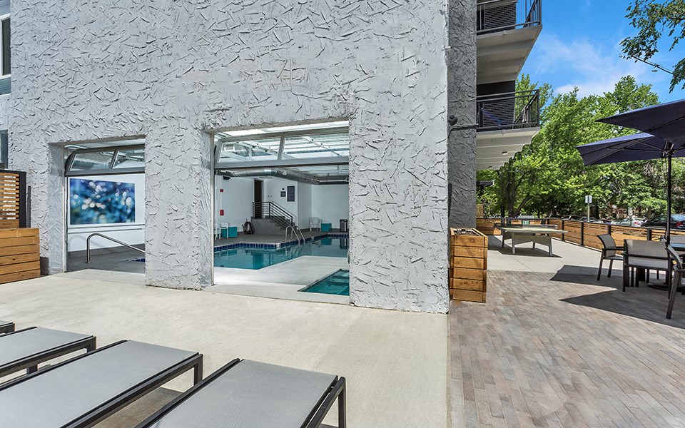 the residence apartment building pool area with tables and chairs