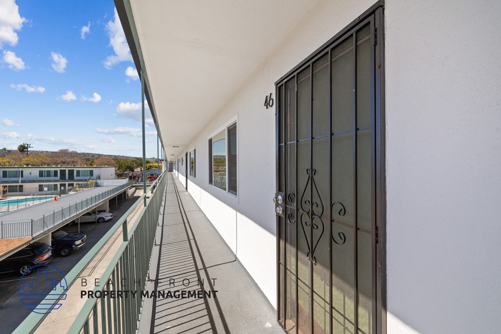 A balcony with a metal railing and a glass door with the number 40 on it.
