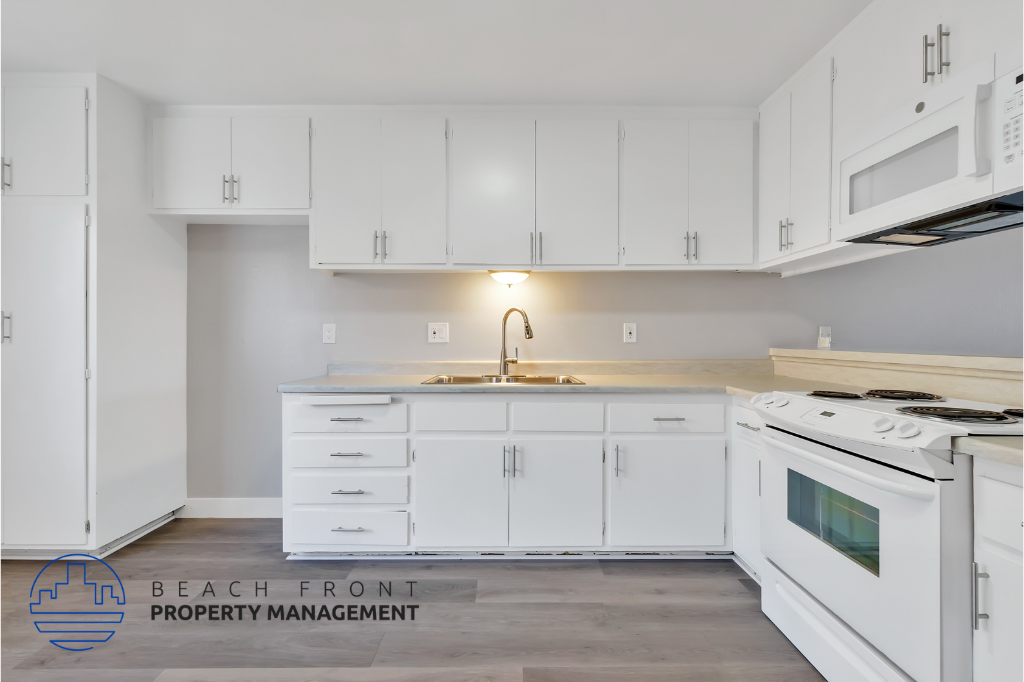 a kitchen with white cabinets and a sink and a stove