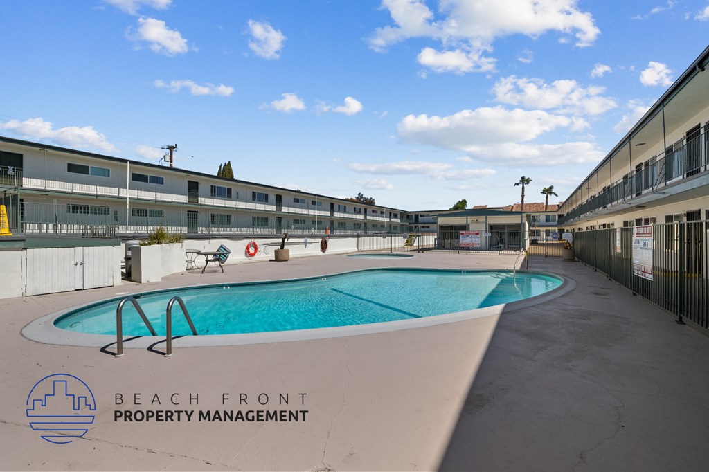 A pool with a logo of Beach Front Property Management.