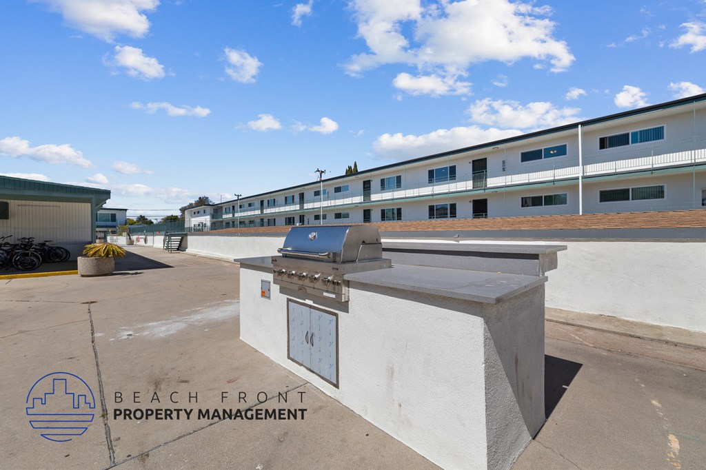 A concrete structure with a logo of Beach Front Property Management on it.