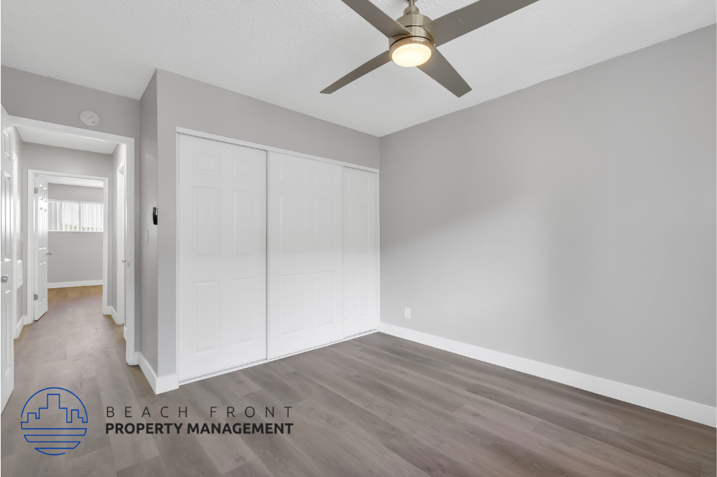 the master bedroom has a large closet and a ceiling fan