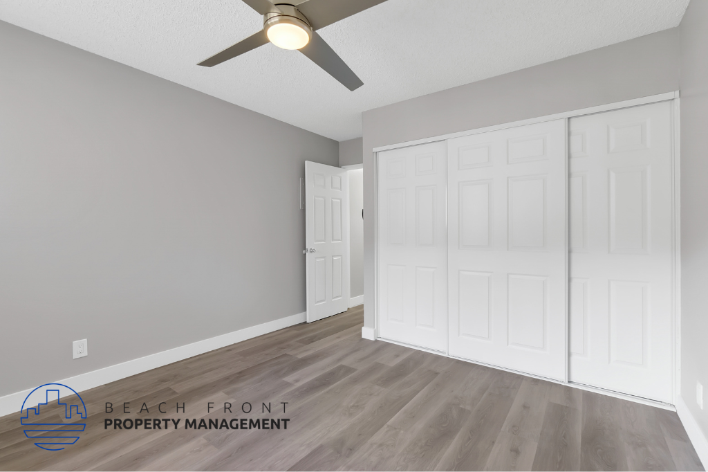 the living room of a new home with white doors and a ceiling fan