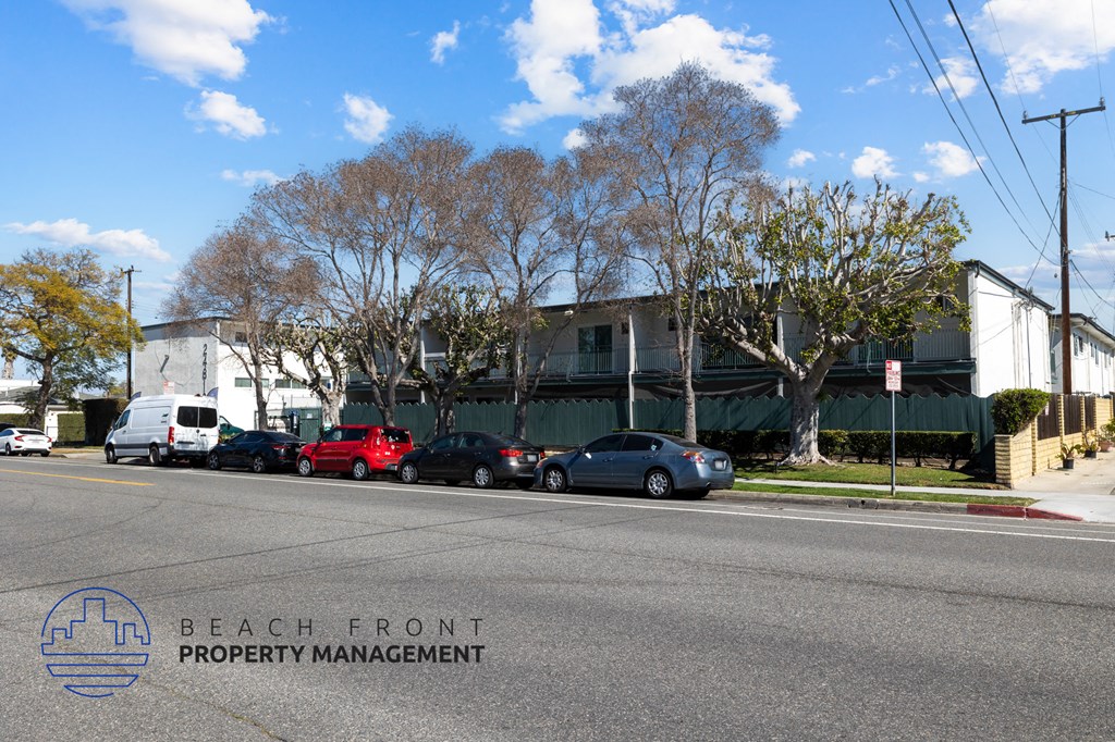 A street view with Beach Front Property Management logo.