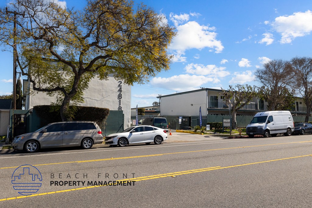 A street view with Beach Front Property Management logo.