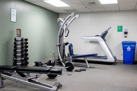 a gym with weights and other exercise equipment in a building