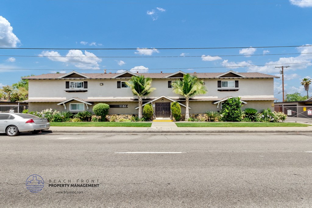 a house on the corner of a street with a car parked in front of it
