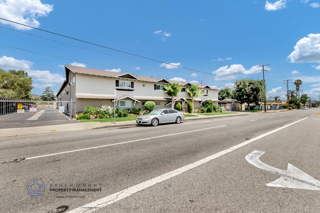 a car parked on the side of the road in front of a house