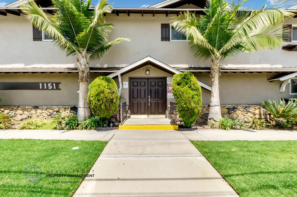 a home with palm trees in front of it