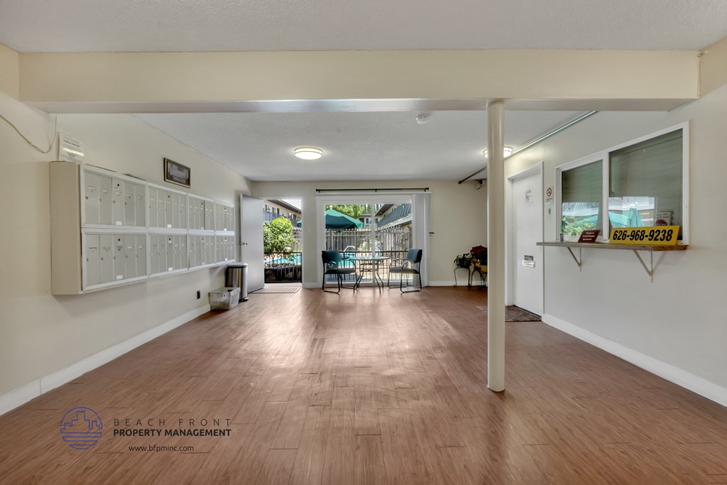 a large room with hardwood floors and white walls
