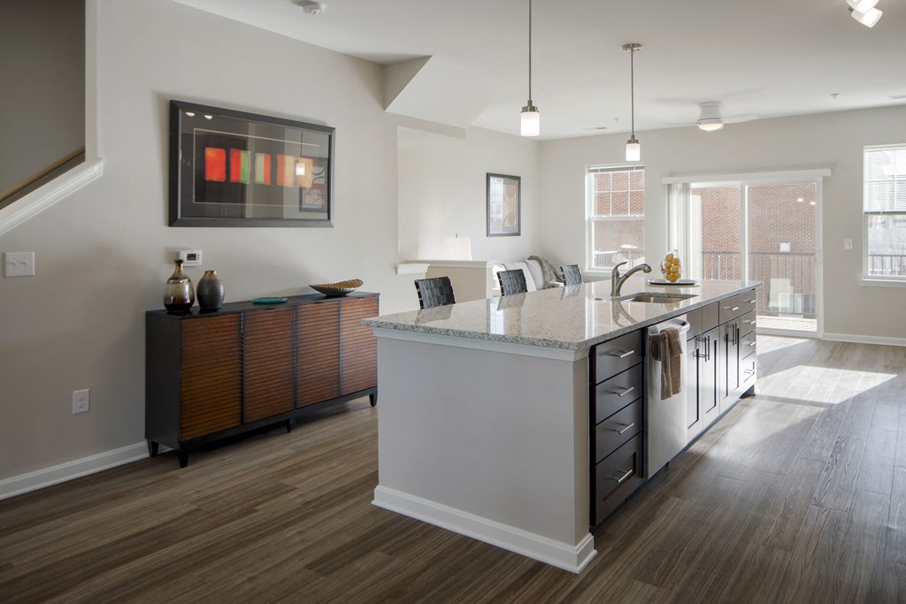 a large kitchen with an island and a living room