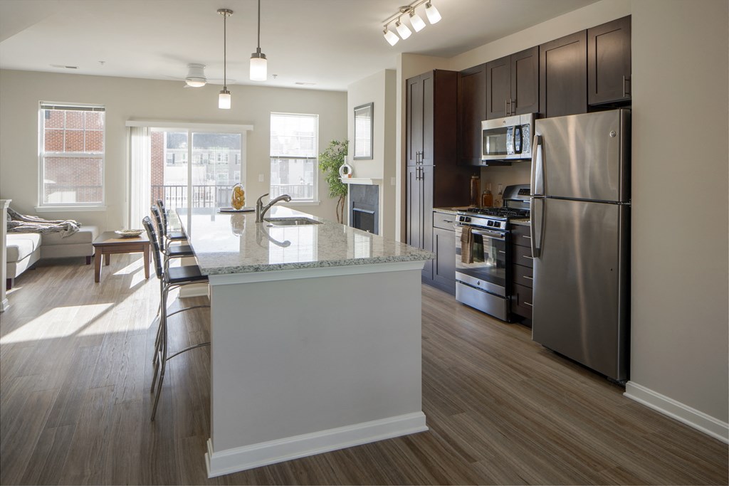 a kitchen with a large island and stainless steel appliances