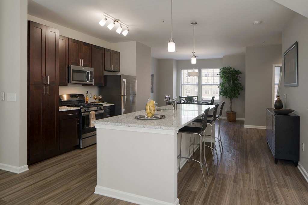 an open kitchen and dining room with a large white island