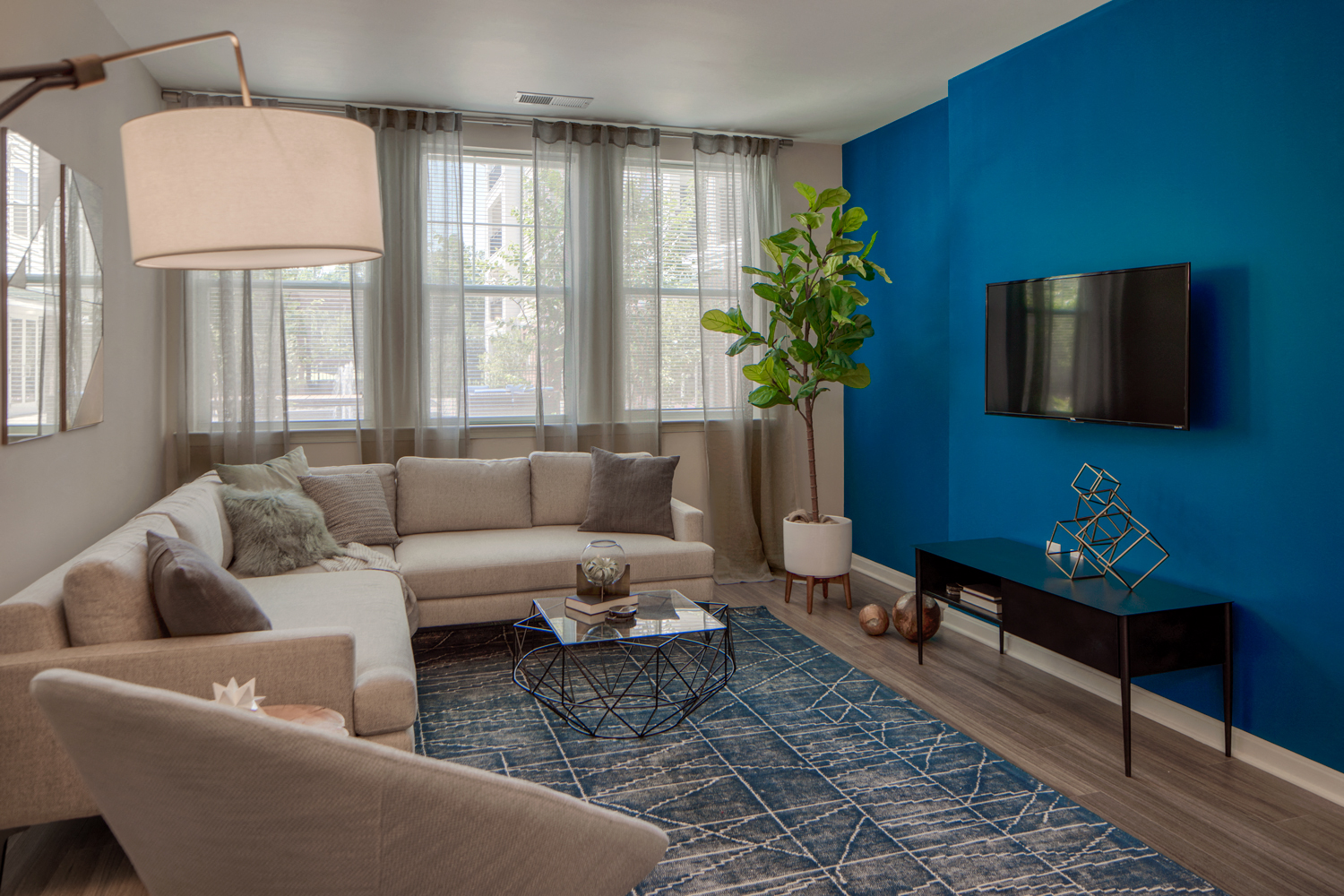 a living room with a blue wall and a couch and a table