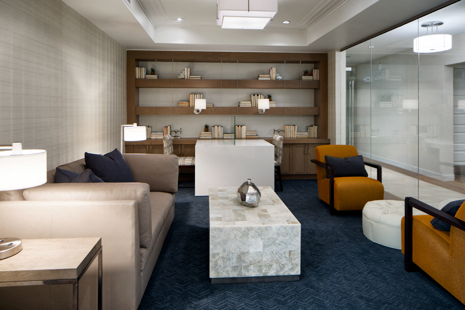 Coffeehouse-style lounge, featuring high-top tables, plush seating areas, wood-beamed ceiling and a grand, gas fireplace with marble surround